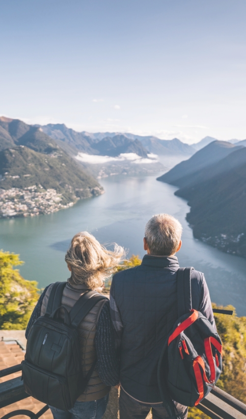 couple looking over water from a hillltop