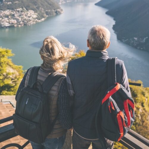 couple looking over water from a hillltop
